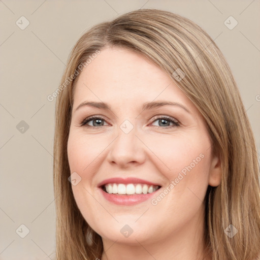 Joyful white young-adult female with long  brown hair and green eyes