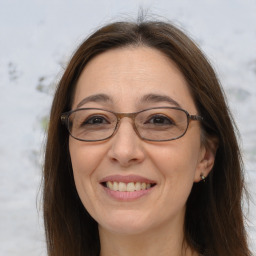 Joyful white adult female with long  brown hair and brown eyes