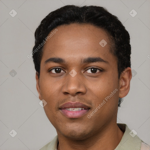 Joyful black young-adult male with short  black hair and brown eyes