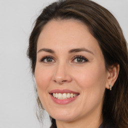 Joyful white adult female with medium  brown hair and brown eyes