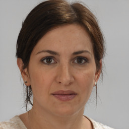 Joyful white adult female with medium  brown hair and brown eyes