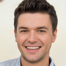 Joyful white young-adult male with short  brown hair and brown eyes