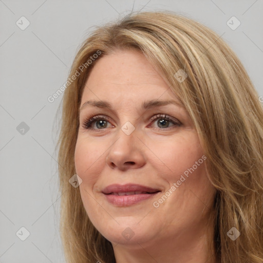 Joyful white adult female with long  brown hair and brown eyes