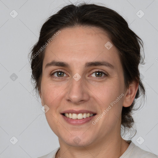 Joyful white adult female with medium  brown hair and brown eyes