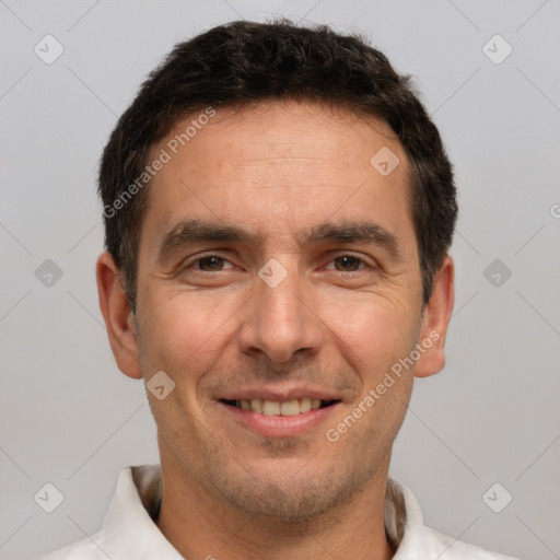 Joyful white adult male with short  brown hair and brown eyes