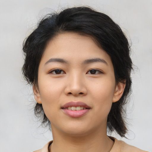 Joyful asian young-adult female with medium  black hair and brown eyes