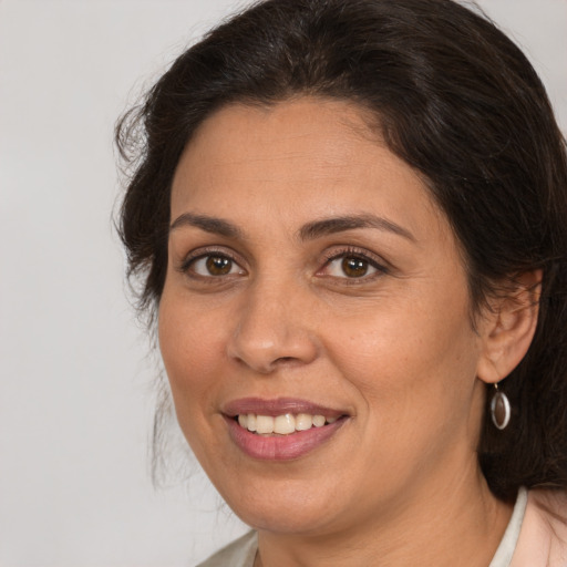 Joyful white adult female with medium  brown hair and brown eyes