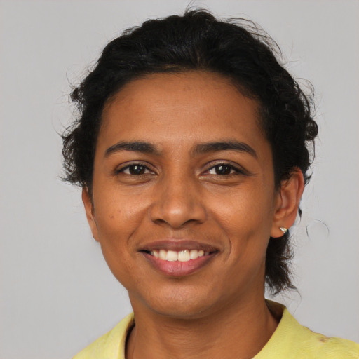 Joyful latino young-adult female with short  brown hair and brown eyes