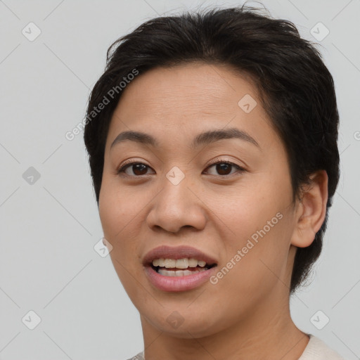 Joyful asian young-adult female with short  brown hair and brown eyes