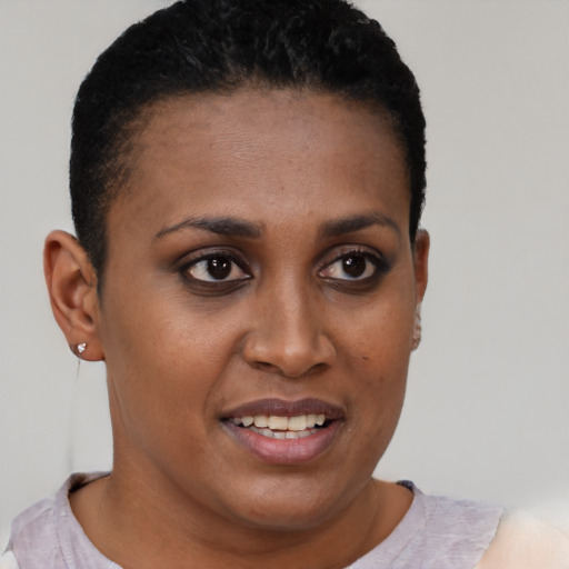 Joyful black young-adult female with short  brown hair and brown eyes