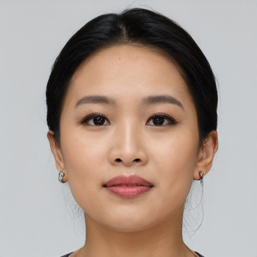 Joyful asian young-adult female with medium  black hair and brown eyes