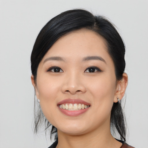 Joyful asian young-adult female with medium  black hair and brown eyes