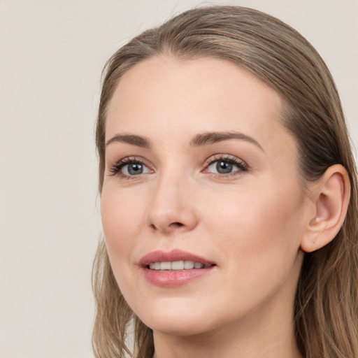 Joyful white young-adult female with long  brown hair and grey eyes