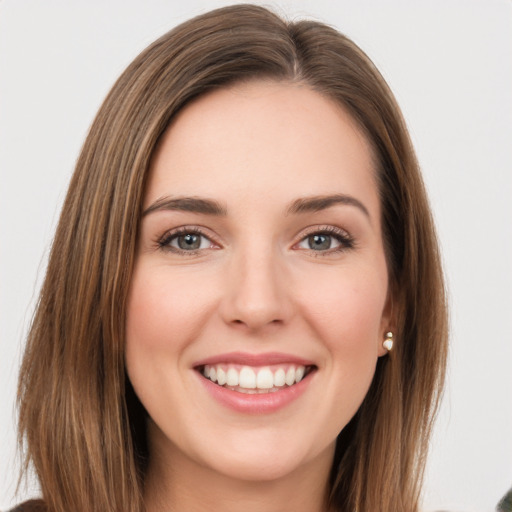 Joyful white young-adult female with long  brown hair and green eyes