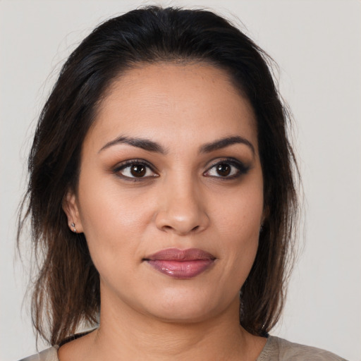 Joyful latino young-adult female with medium  brown hair and brown eyes