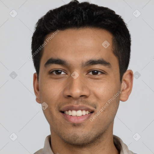 Joyful latino young-adult male with short  black hair and brown eyes