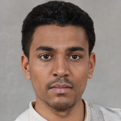 Neutral latino young-adult male with short  black hair and brown eyes