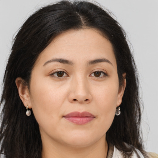 Joyful asian young-adult female with long  brown hair and brown eyes