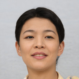 Joyful asian young-adult female with short  brown hair and brown eyes