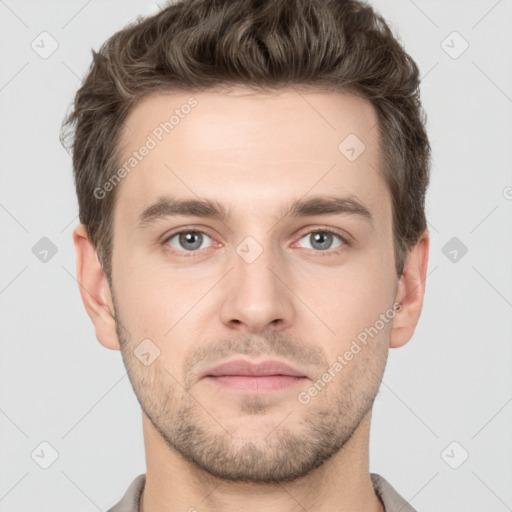 Joyful white young-adult male with short  brown hair and grey eyes