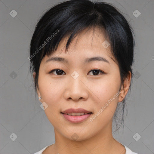 Joyful asian young-adult female with medium  black hair and brown eyes