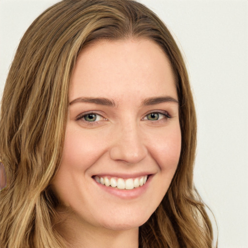 Joyful white young-adult female with long  brown hair and green eyes