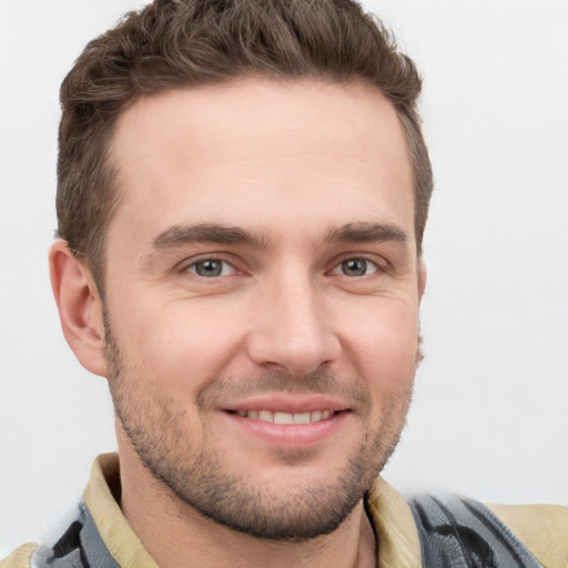 Joyful white young-adult male with short  brown hair and brown eyes