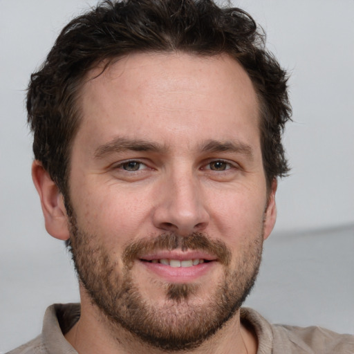 Joyful white adult male with short  brown hair and brown eyes