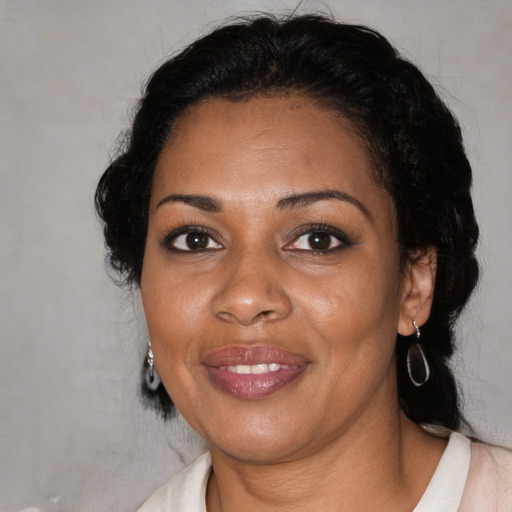 Joyful black adult female with medium  black hair and brown eyes