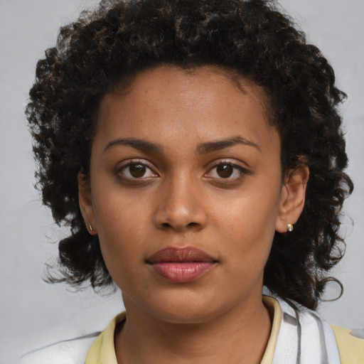 Neutral black young-adult female with medium  brown hair and brown eyes