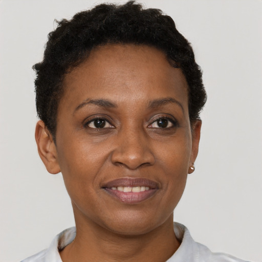 Joyful black young-adult female with short  brown hair and brown eyes
