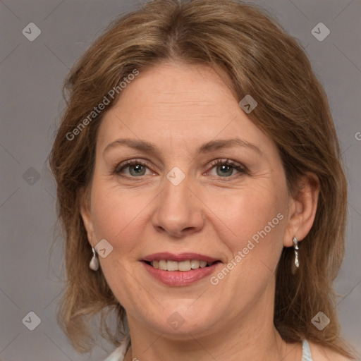 Joyful white adult female with medium  brown hair and grey eyes