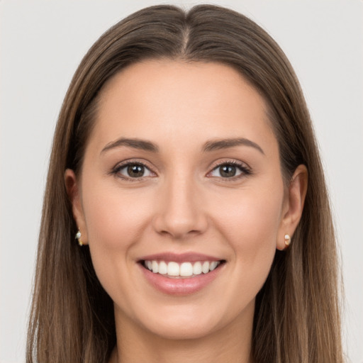 Joyful white young-adult female with long  brown hair and brown eyes