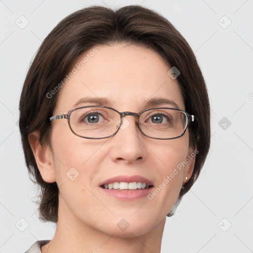 Joyful white adult female with medium  brown hair and grey eyes