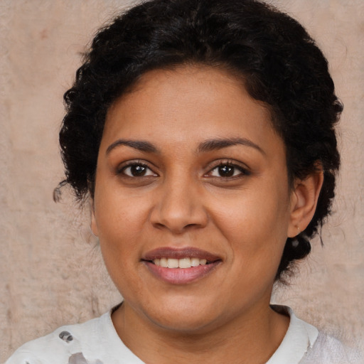 Joyful latino young-adult female with medium  brown hair and brown eyes