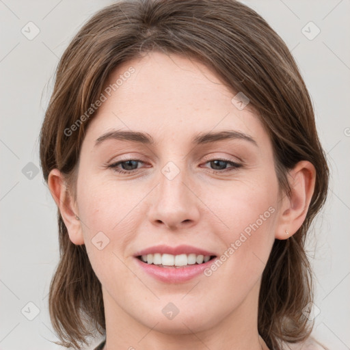 Joyful white young-adult female with medium  brown hair and blue eyes