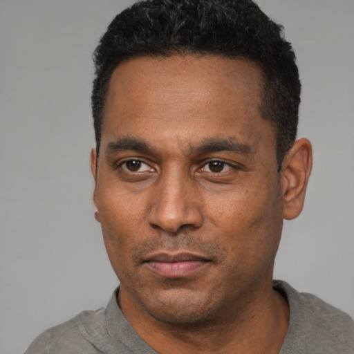 Neutral latino adult male with short  black hair and brown eyes