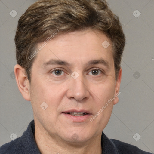 Joyful white adult male with short  brown hair and grey eyes