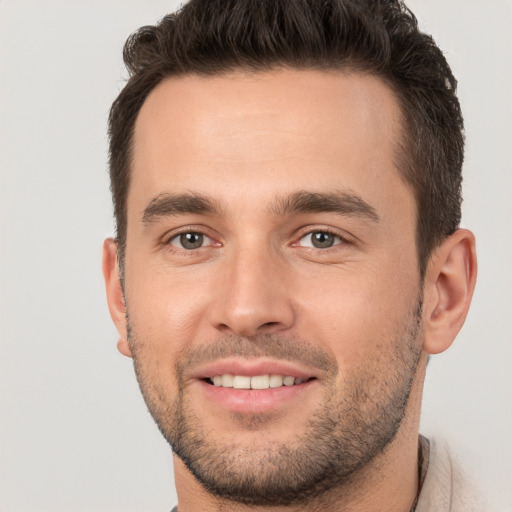 Joyful white young-adult male with short  brown hair and brown eyes