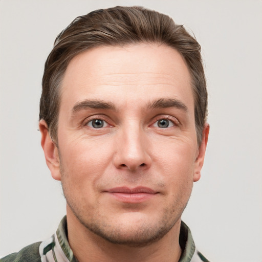 Joyful white young-adult male with short  brown hair and grey eyes