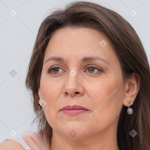 Joyful white adult female with long  brown hair and brown eyes