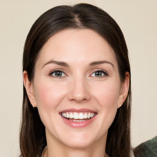 Joyful white young-adult female with long  brown hair and green eyes