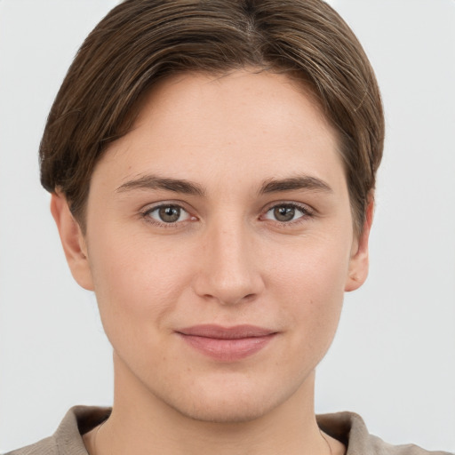 Joyful white young-adult female with short  brown hair and grey eyes