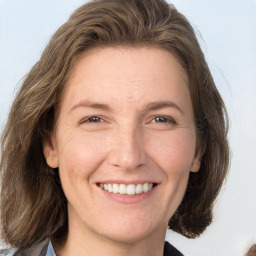 Joyful white adult female with medium  brown hair and grey eyes