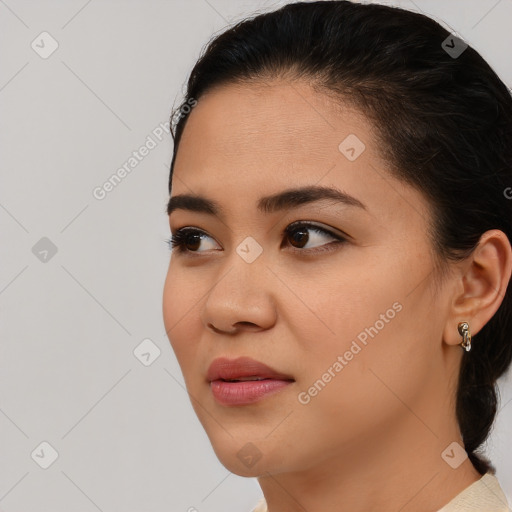 Joyful asian young-adult female with short  brown hair and brown eyes