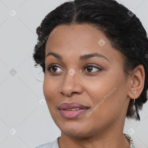 Joyful black young-adult female with short  brown hair and brown eyes