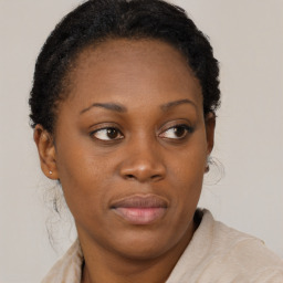 Joyful black young-adult female with short  brown hair and brown eyes