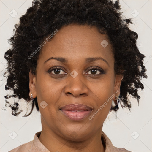 Joyful black adult female with short  brown hair and brown eyes