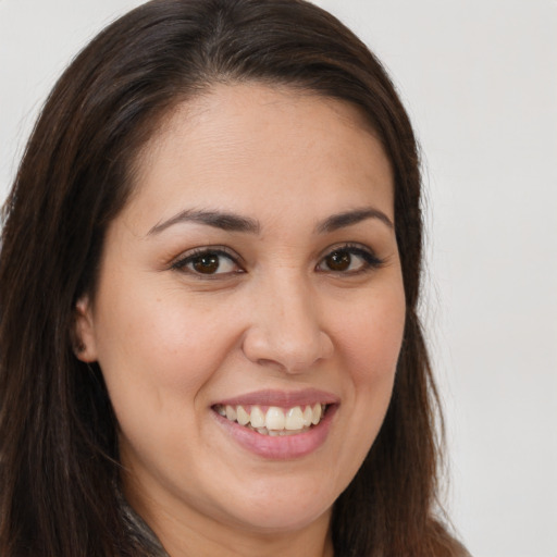 Joyful white young-adult female with long  brown hair and brown eyes