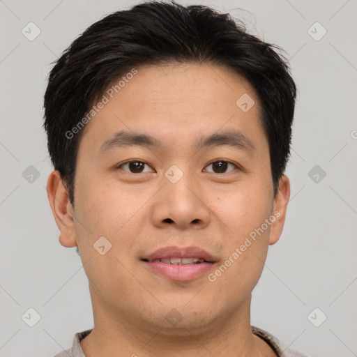 Joyful asian young-adult male with short  brown hair and brown eyes